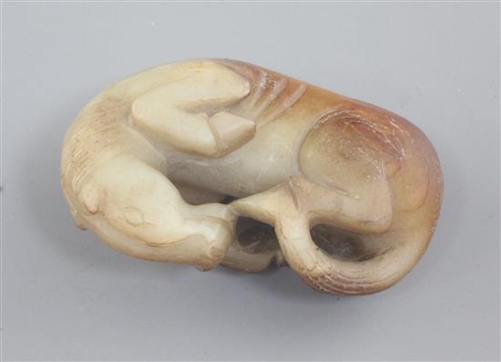 A Chinese yellow and russet jade figure of a recumbent horse, 8.5cm